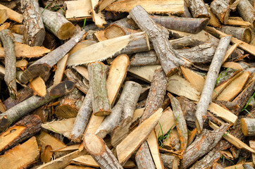 Chopped wood for the fireplace close-up. Wooden logs. Autumn natural background. Copy space. Selective focus image.