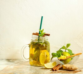 Summer detox cocktail with lime, mint and ginger, in a glass Cup on a light background, vertical orientation with space