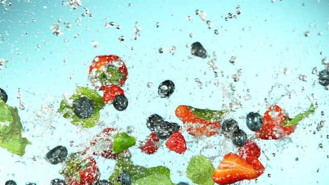 Super slow motion of berries fruit flying up in the air with water splashes. Filmed on high speed cinema camera, 1000 fps.