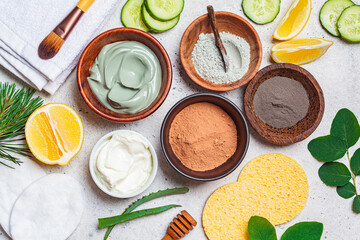 Different types of dry clay in wooden bowls for the preparation of facial masks, top view. Skincare concept.