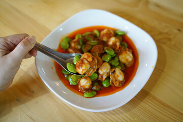 Spicy Stir-Fried Twisted cluster bean (Bitter bean or Stink bean) with scallop paste, Traditional Southern Thai food recipe, Popular in Thailand.