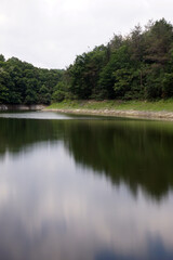 Fototapeta na wymiar Lake in the forest, reflection in the water, beautiful scenery