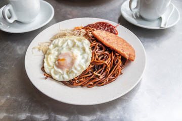 close up of fried noodles with luncheon meat and egg