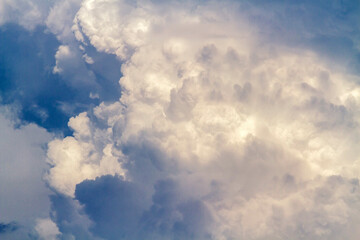Fototapeta na wymiar Fluffy white clouds flying on blue sky background