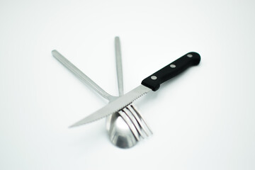 stainless sppon fork and knife on white background
