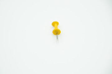 isolated yellow pushpin in a white background