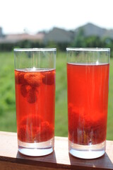 Traditional European non-alcoholic fruit beverage compote made from strawberries and rhubarb in summer