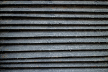 Blue ventilation in the wall of an old building. Textured blinds. Beautiful background. High quality photo