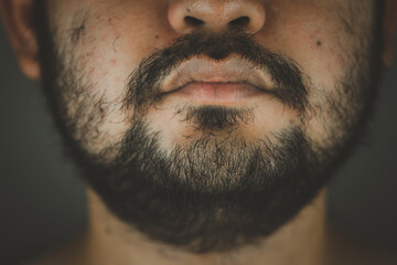 Close up face of a Asian man with a beard and thick mustache