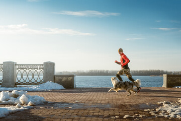 Jogging. Running with dog. Morning training.