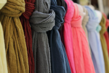 Colored fabric  scarfs in rows at market. 
