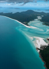 Beautiful aerial view of turquoise water, white sandy beaches and green forests in the tropical wonder of the Whitsundays islands, Queensland, Australia. Concept for summer, travelling and vacation