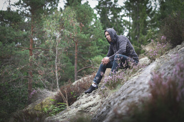 Obraz premium Adult man lost while hiking in the forest.