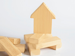 Mini wooden house on white background. Conceptual image.