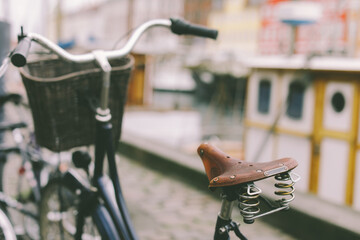 A bike with  basket parked on a street in Copenhagen city
