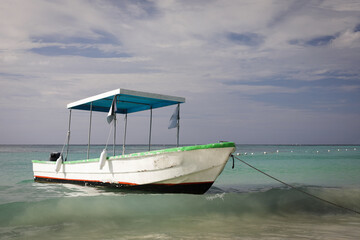 Naklejka na ściany i meble Old boat on caribbean beach in summer