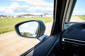 Dirty side rear-view mirror on a modern car.
