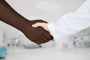 Doctor's hands holding patient's hand for encouragement and empathy. Partnership, trust and medical...