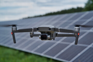Drone on the background of solar panels. Quadrocopter at the photovoltaic plant.