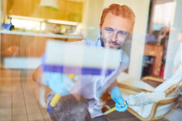 Man as a window cleaner cleans glass window