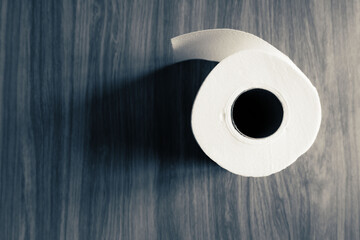 top view of Tissue roll paper on wooden table with dark tone