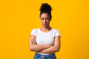 Portrait of offended black woman with folded arms