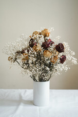 a bouquet of dry roses and gypso flowers 