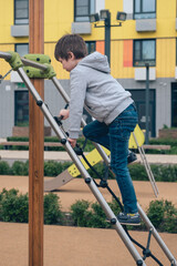 Handsome cute ten year old boy is playing on playground