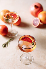 Summer cocktail with blood orange, grapefruit and rosemary