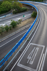 View of access curve to M30 with 40 km limit, empty, at sunset, in Madrid, Spain, vertically