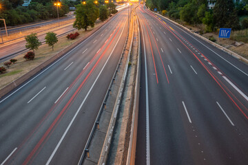Top view of M30 motorway, at sunset, with red trails of car lights, in Madrid, Spain, horizontal
