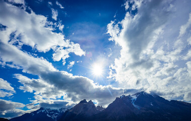 Bright Sun in the Blue Cloudy sky in the Torres Del Paine National Park, Chile