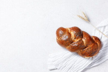 Homemade crusty loave of wheat candy bun with poppy seed
