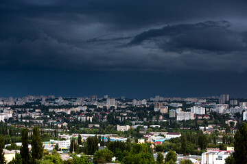 Fototapeta premium Chisinau, the capital city of the Republic of Moldova. Storm clouds over city. Cloud over the city at the sunset.