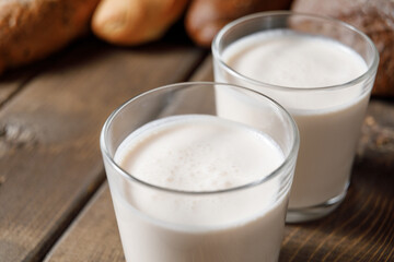 Probiotic cold fermented dairy drink kefir on wooden background.
