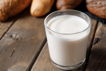 Probiotic cold fermented dairy drink kefir on wooden background.
