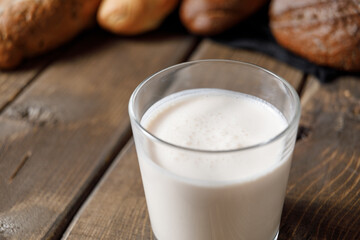 Probiotic cold fermented dairy drink kefir on wooden background.