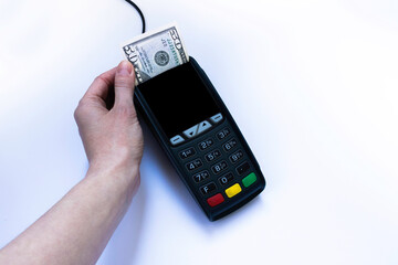 Female hand taking a 50 dollars from payment terminal instead of a check