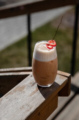 cold refreshing cocktail on a wood on a summer sunny day