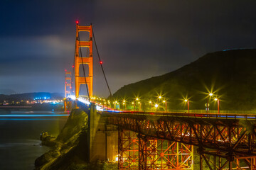 Golden Gate Bridge in San Francisco at night with light bursts