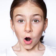 Closeup portrait of a surprised indignant girl on a white background