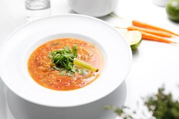 Lebanese red lentil soup with lime and coriander. A plate of aromatic and healthy soup.