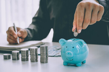 Man putting coin in piggy bank. saving money, budget, investment, finance concept