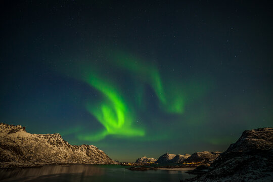 Dramatic aurora borealis, polar lights, over mountains in the North of Europe - Lofoten islands, Norway © Tatiana