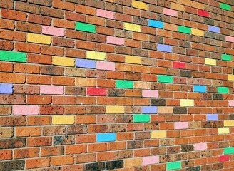 Brick wall with colorful painted bricks