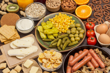 Sausages in pan. Cheese, vegetables, cookies cereal: ingredients for  continental breakfast.