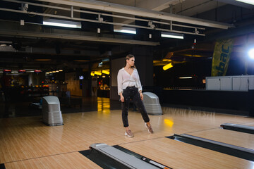 Beautiful caucasian woman on a bowling alley track