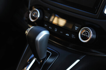 Fototapeta na wymiar Close up of the manual gearbox transmission handle. Accelerator handle and buttons in a new car.
