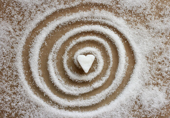 Fototapeta na wymiar A heart-shaped sugar candy in the center of the sugar spiral