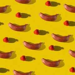 Creative geometric seamless pattern with fruits. Repeating banana and strawberry on a yellow background.